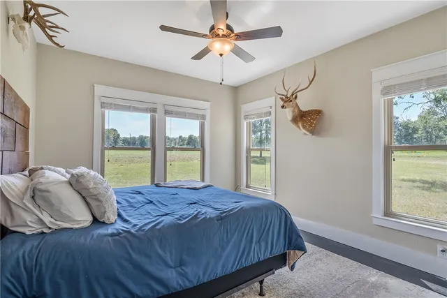 a bedroom with a large bed and a chandelier