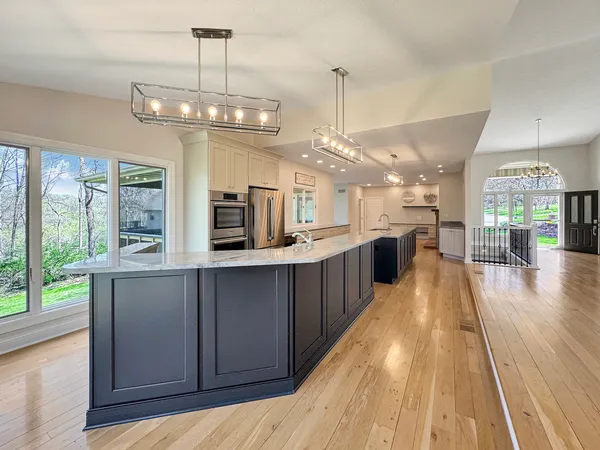 a view of empty room with wooden floor and fireplace