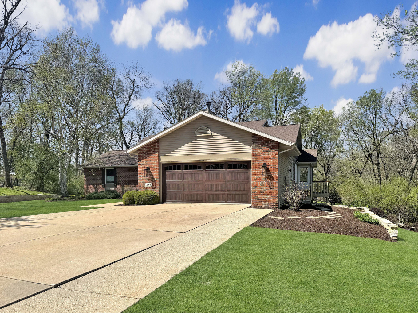 1669 Barberry Circle Freeport, IL 61032 - Photo 2 of 67 a front view of a house with a yard and garage