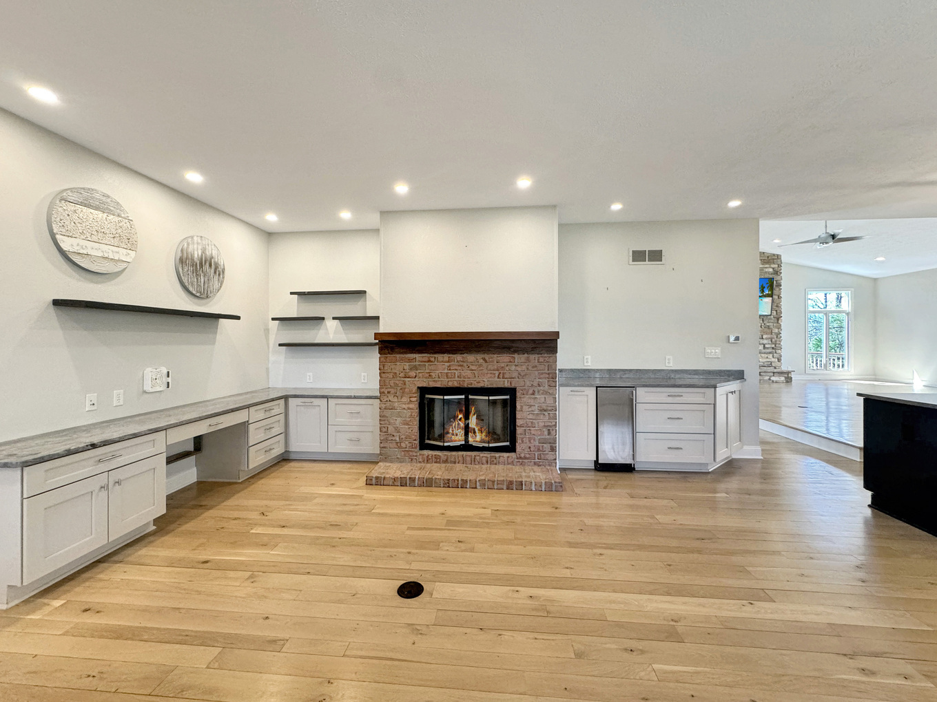 1669 Barberry Circle Freeport, IL 61032 - Photo 22 of 67 a large kitchen with stainless steel appliances granite countertop a stove top oven a sink dishwasher and a fireplace with wooden floor