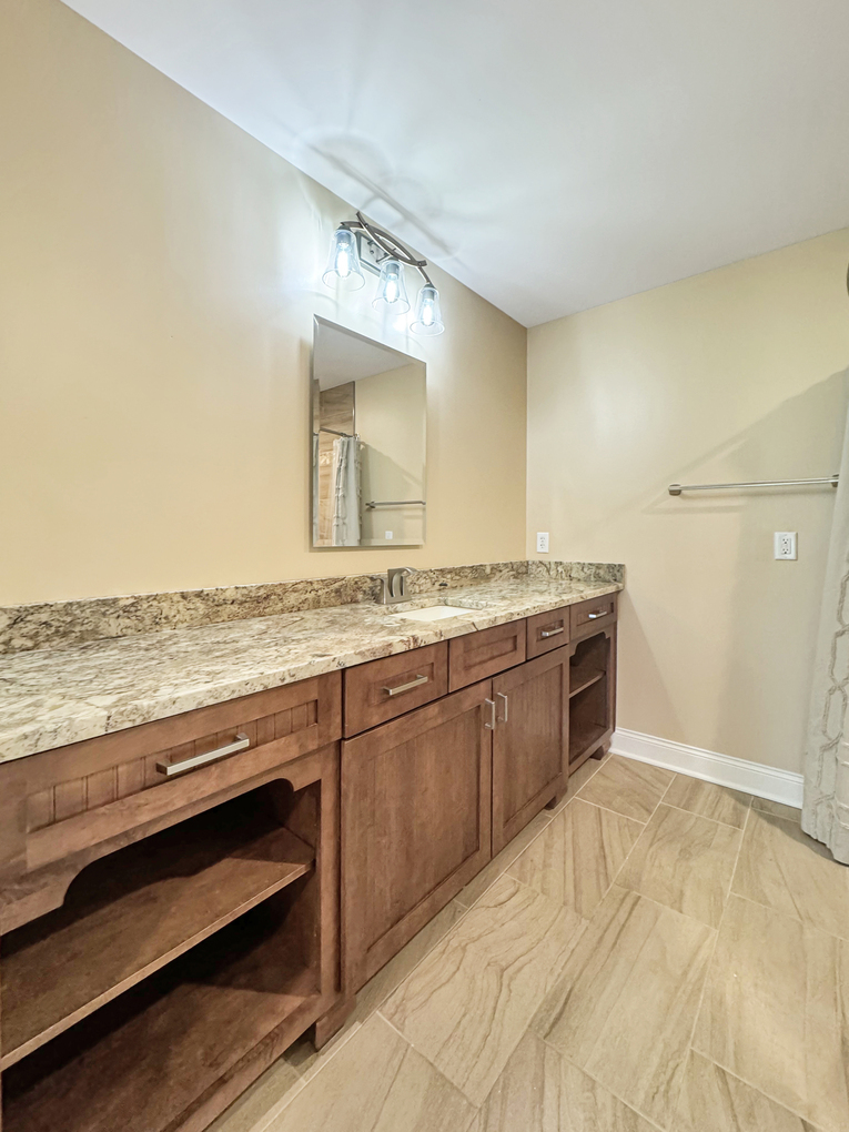 1669 Barberry Circle Freeport, IL 61032 - Photo 42 of 67 a spacious bathroom with a granite countertop sink and a mirror