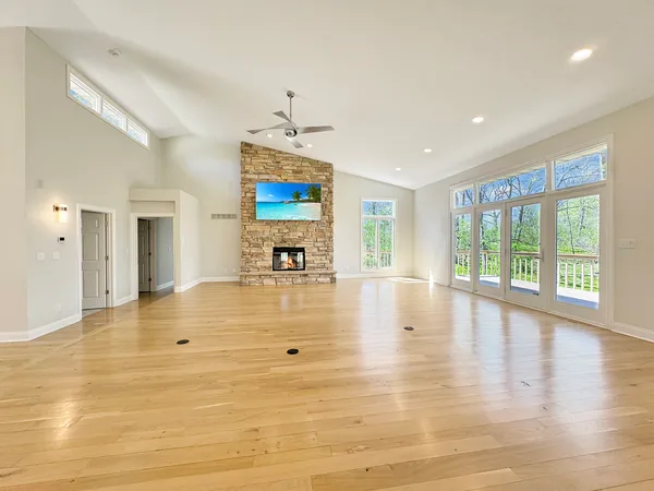 a kitchen with stainless steel appliances granite countertop a stove and a wooden floors