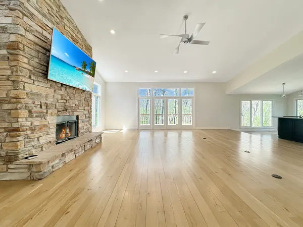 a view of a room with wooden floor chandelier and entryway