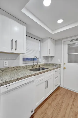 a white refrigerator freezer sitting inside of a kitchen