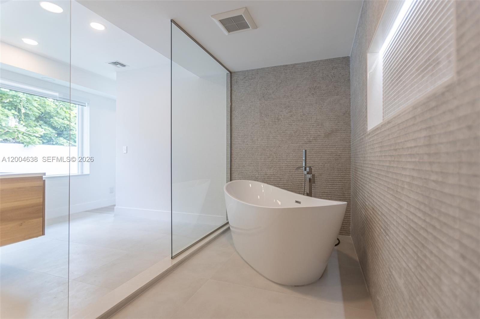 1690 Daytonia Road Miami Beach, FL 33141 - Photo 64 of 88 a bathroom with a sink mirror and window