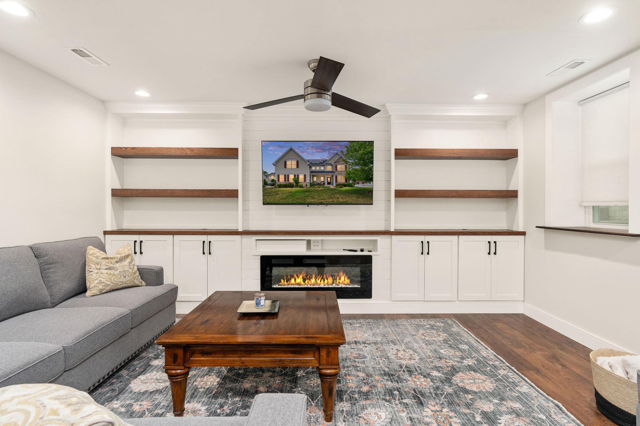 9417 Reservoir Road Fredericksburg, VA 22407 - Photo 35 of 76 a living room with furniture and a fireplace