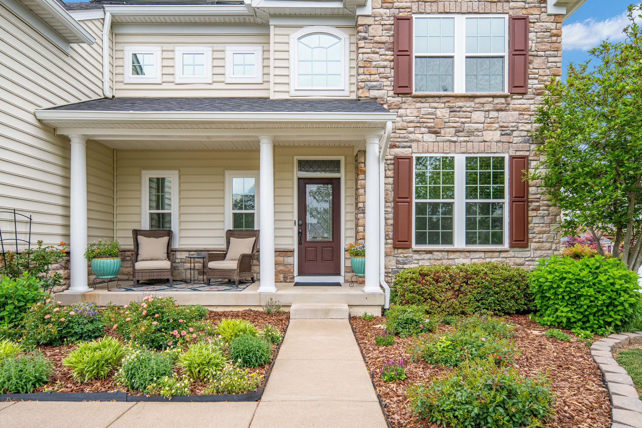9417 Reservoir Road Fredericksburg, VA 22407 - Photo 4 of 76 front view of a brick house with large windows and potted plants