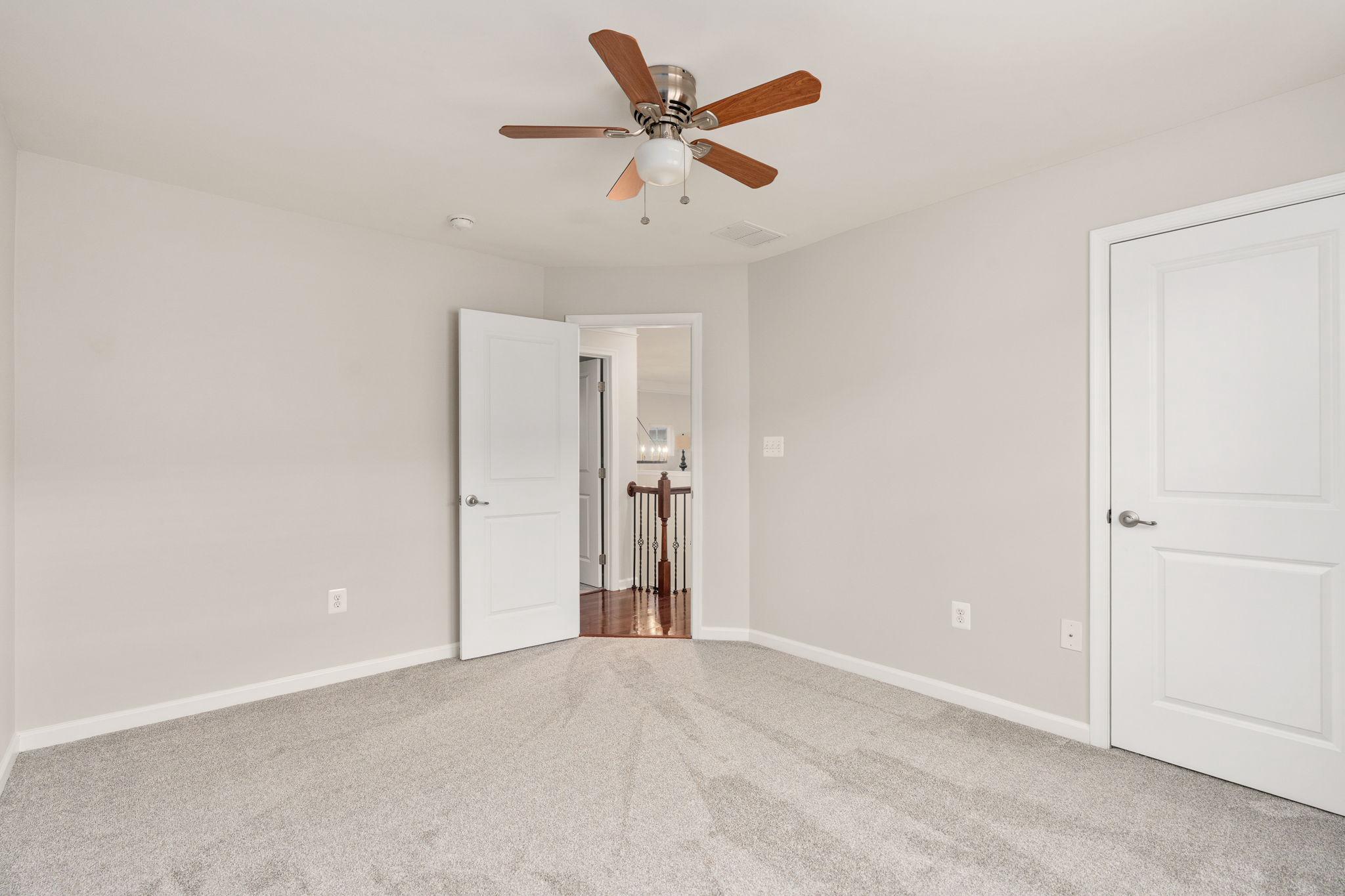 9417 Reservoir Road Fredericksburg, VA 22407 - Photo 51 of 76 an empty room with closet and ceiling fan