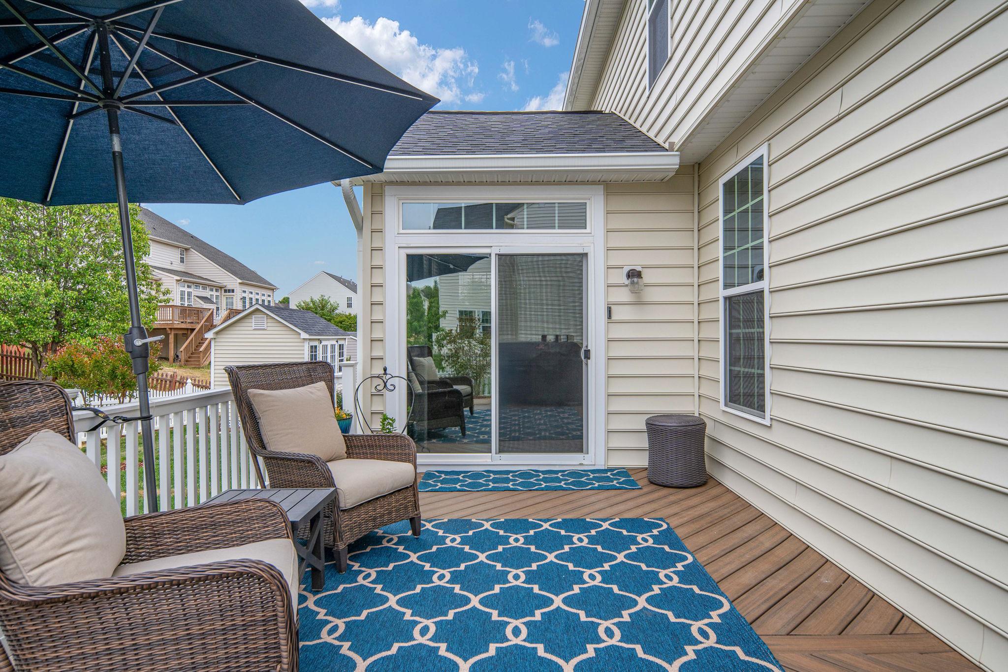 9417 Reservoir Road Fredericksburg, VA 22407 - Photo 65 of 76 a view of a patio with a table and chairs under an umbrella