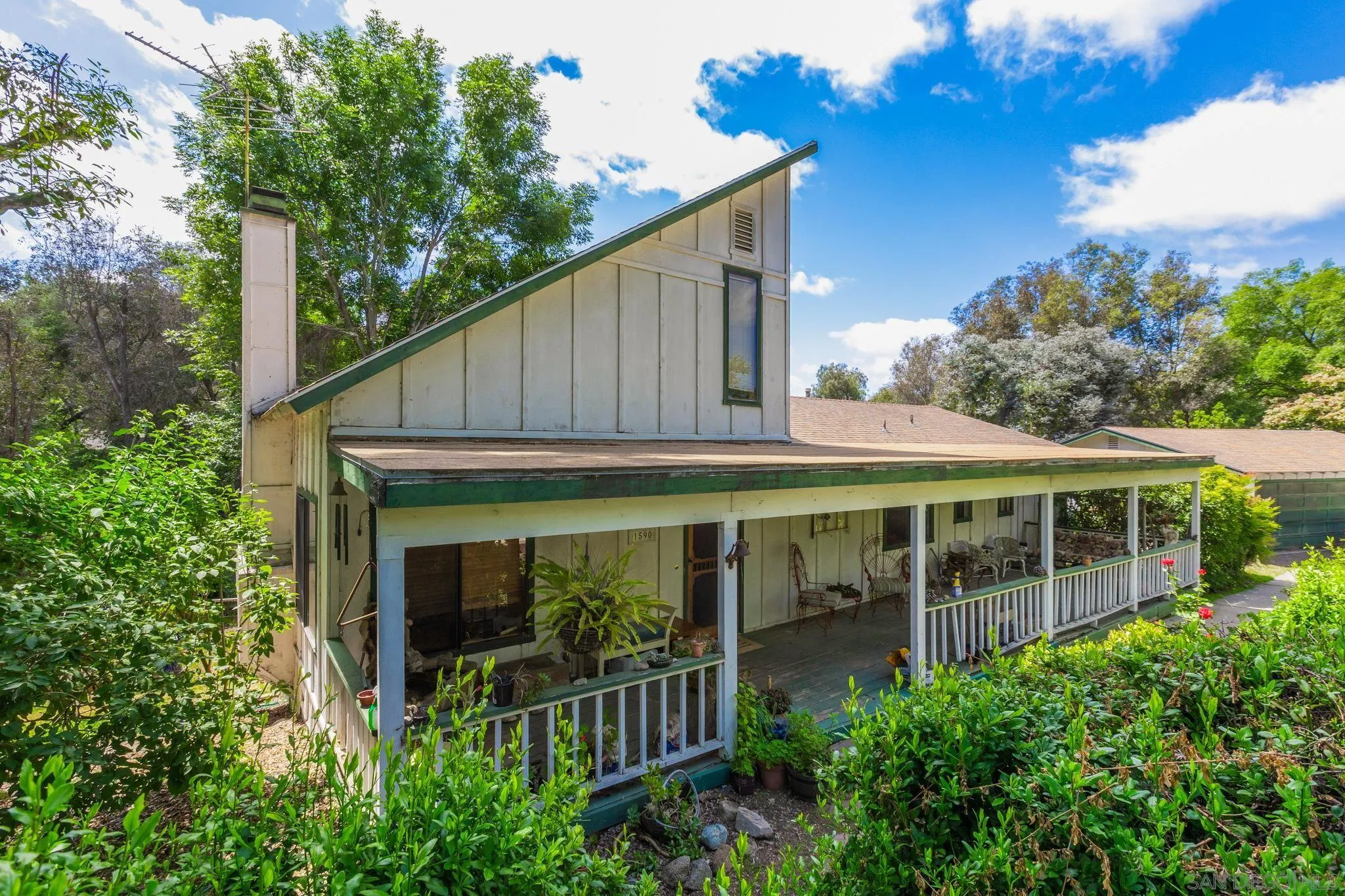 a view of a house with a yard balcony and plants