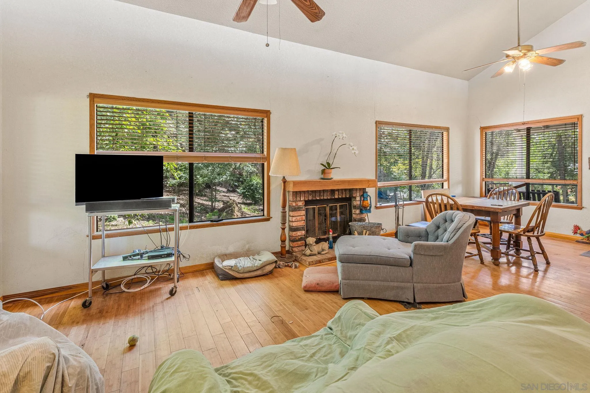 1590 Dorothea Avenue Fallbrook, CA 92028 - Photo 11 of 33 a living room with furniture floor to ceiling window hardwood floor and a flat screen tv