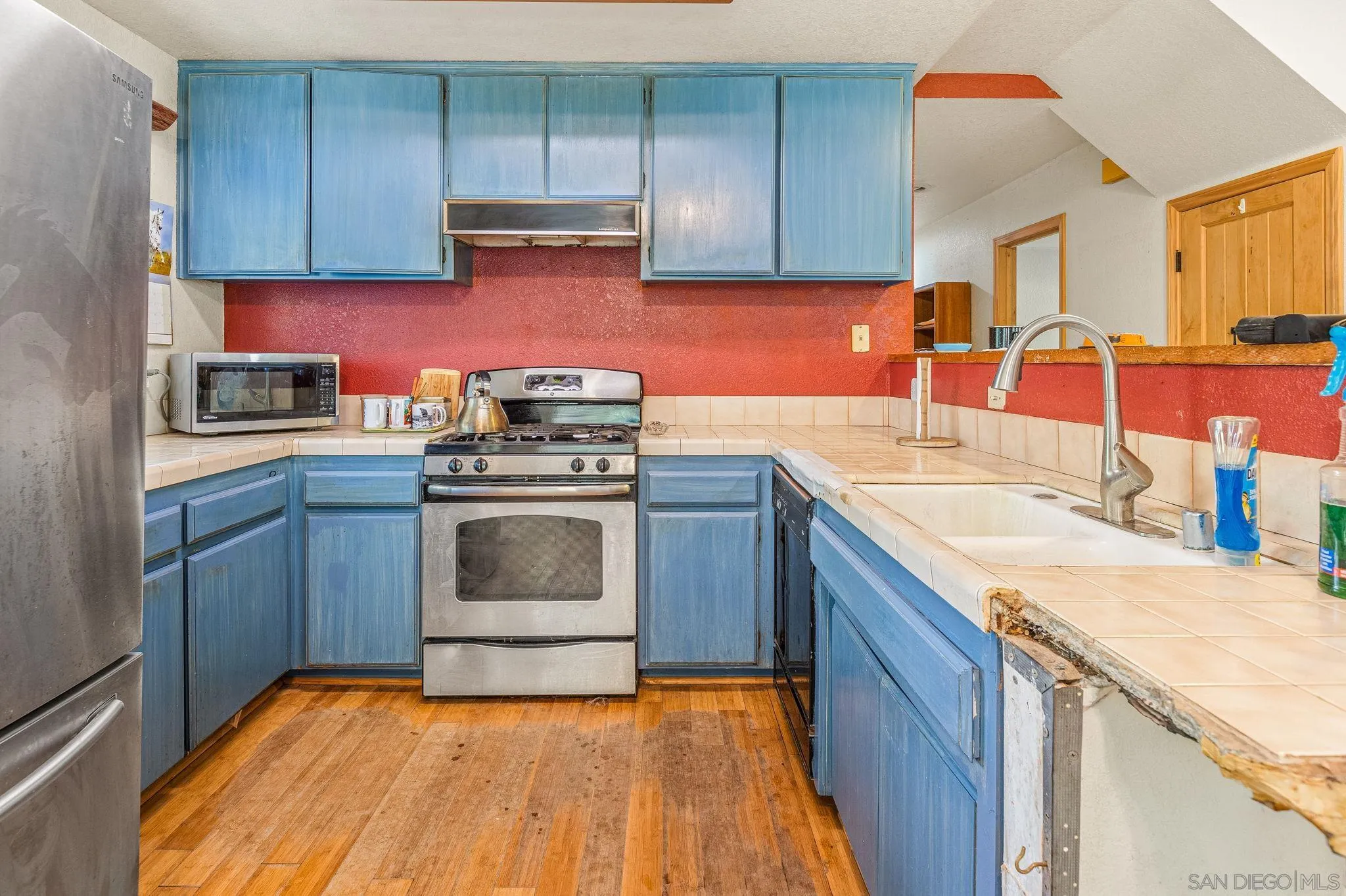 1590 Dorothea Avenue Fallbrook, CA 92028 - Photo 6 of 33 a kitchen with granite countertop a sink a stove and cabinets