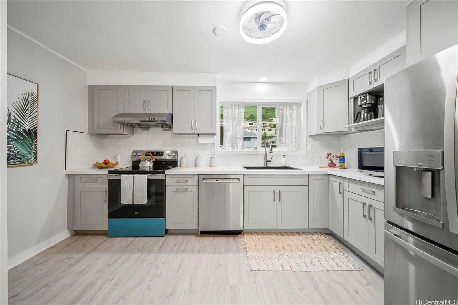 809 Hao Street Honolulu, HI 96821 - Photo 14 of 25 a kitchen with a sink cabinets stainless steel appliances and a window