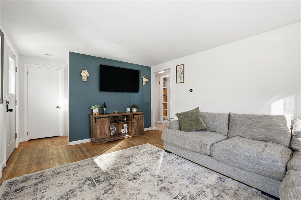 180 Wolcott Avenue West Springfield, MA 01089 - Photo 8 of 39 a living room with a couch and a flat screen tv