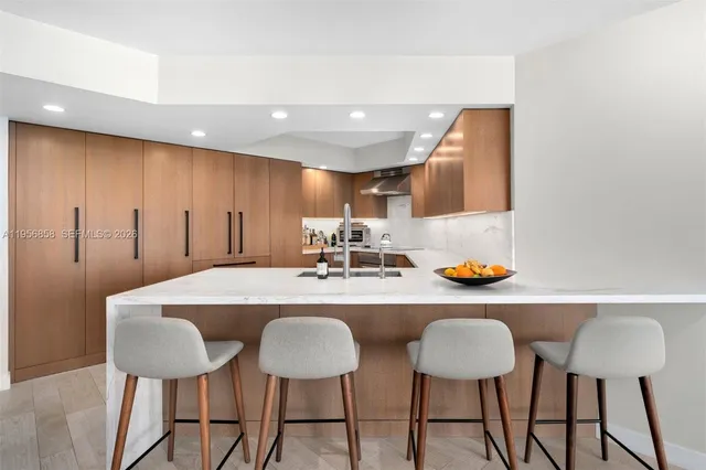 a kitchen with a dining table chairs and white cabinets