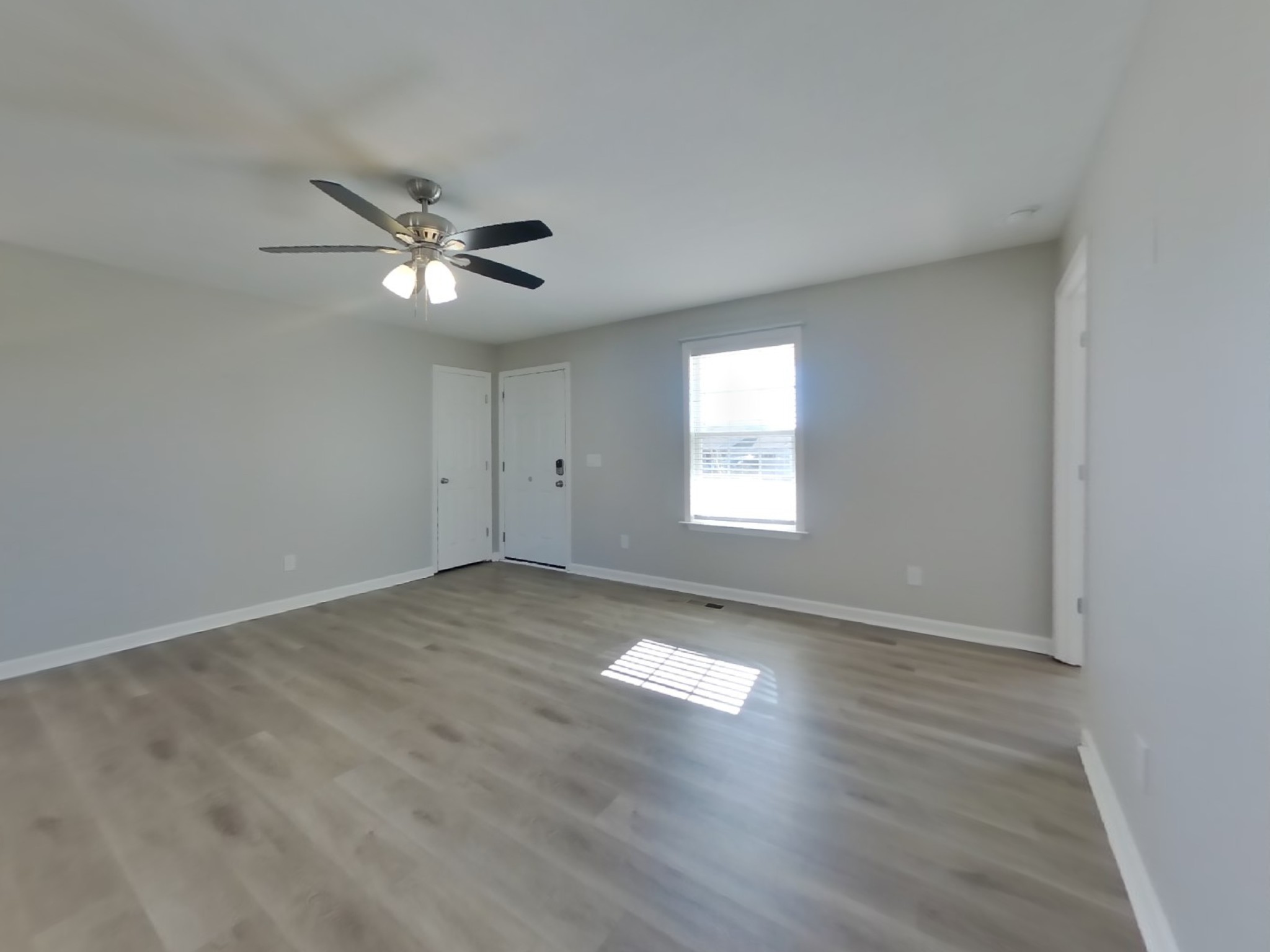 1612 Robert Road Columbia, TN 38401 - Photo 3 of 15 an empty room with wooden floor and windows