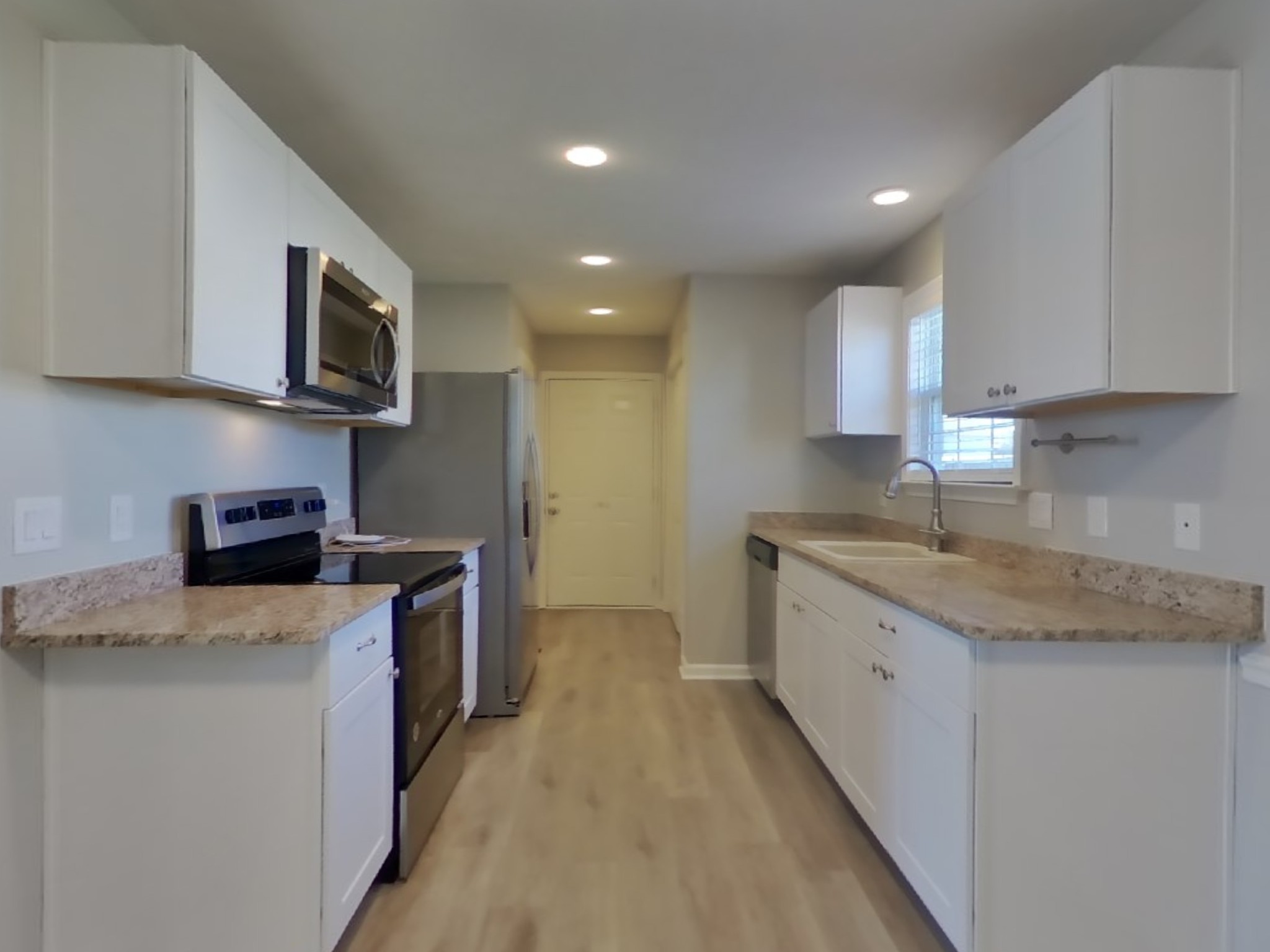 1612 Robert Road Columbia, TN 38401 - Photo 5 of 15 a kitchen with stainless steel appliances granite countertop a sink stove and microwave