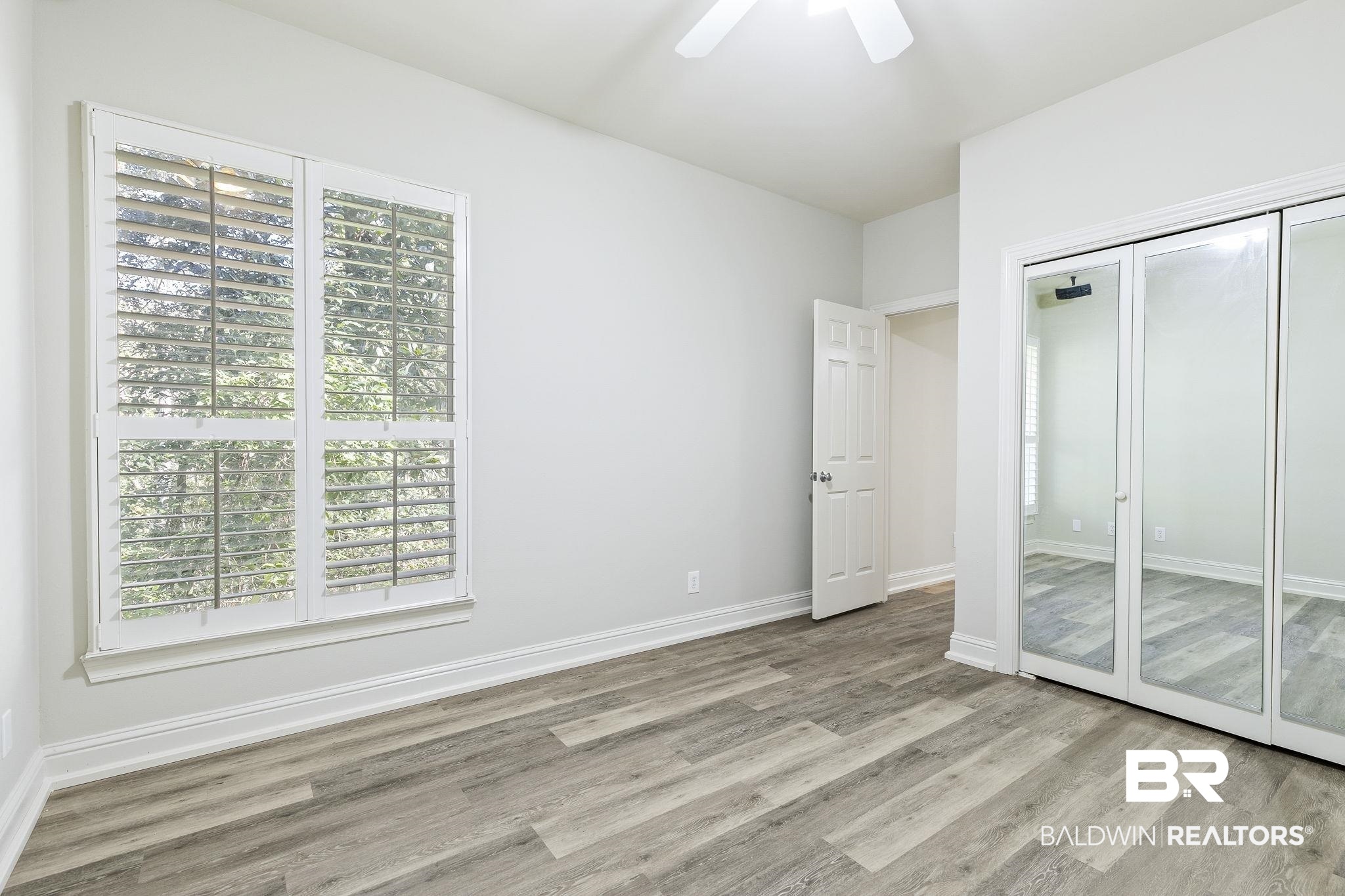13 Bugle Retreat Daphne, AL 36527 - Photo 22 of 40 Unfurnished bedroom featuring ceiling fan, a closet, and light hardwood / wood-style flooring