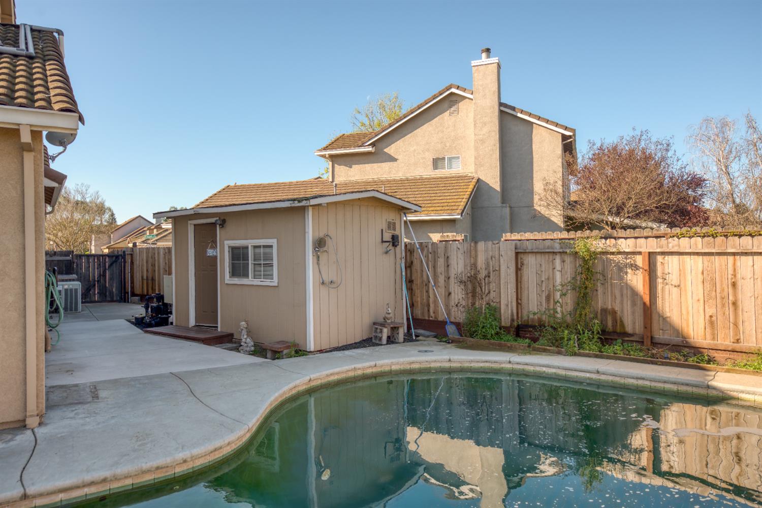 3601 Chant Drive Modesto, CA 95355 - Photo 20 of 23 a view of a small white house with a swimming pool