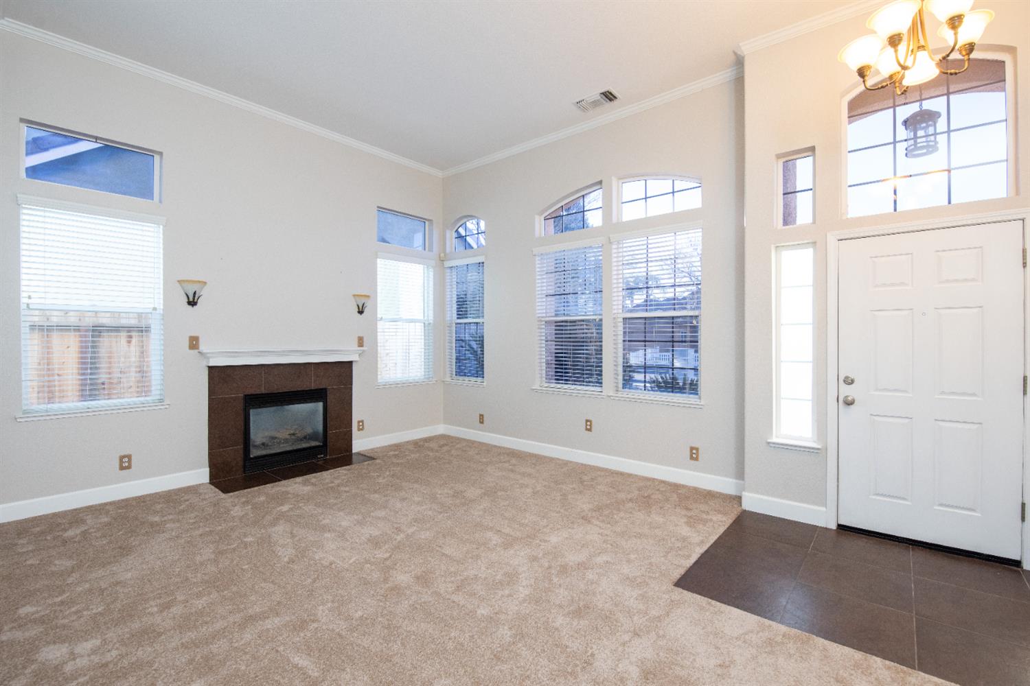 3601 Chant Drive Modesto, CA 95355 - Photo 2 of 23 a view of an empty room with a fireplace and a window