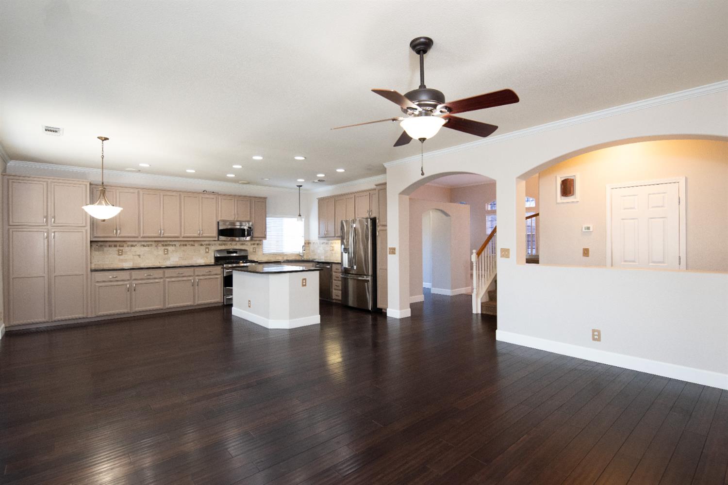 3601 Chant Drive Modesto, CA 95355 - Photo 6 of 23 a view of a kitchen with kitchen island wooden floor appliances and a ceiling fan