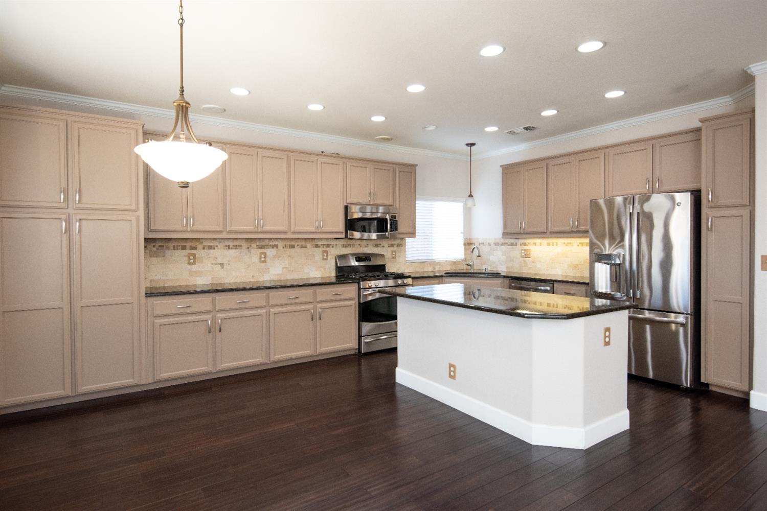 3601 Chant Drive Modesto, CA 95355 - Photo 7 of 23 a kitchen with stainless steel appliances granite countertop a refrigerator a stove a sink and a microwave