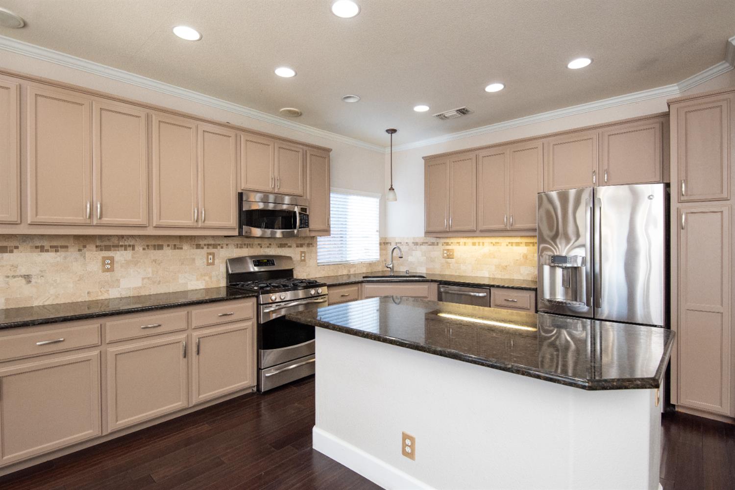 3601 Chant Drive Modesto, CA 95355 - Photo 8 of 23 a kitchen with granite countertop white cabinets and stainless steel appliances