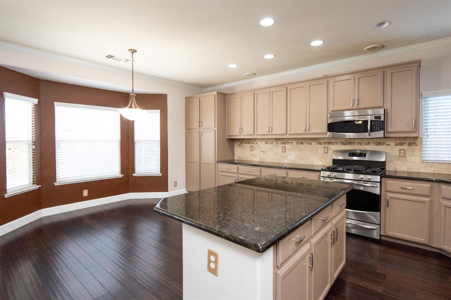3601 Chant Drive Modesto, CA 95355 - Photo 9 of 23 a kitchen with stainless steel appliances granite countertop a sink a stove and a refrigerator