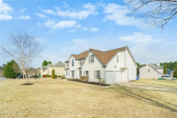 a view of a white house with a yard