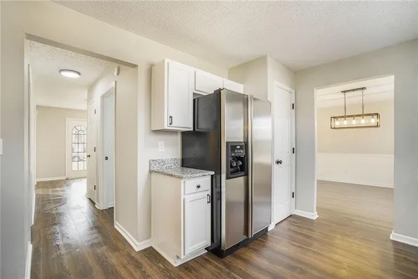 a kitchen with stainless steel appliances a refrigerator and a stove top oven