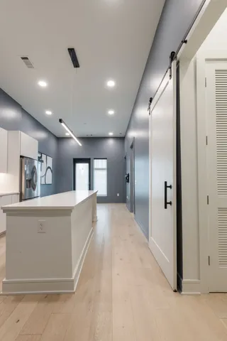 a bedroom with furniture and a flat screen tv