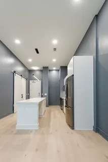 a living room with furniture and kitchen view