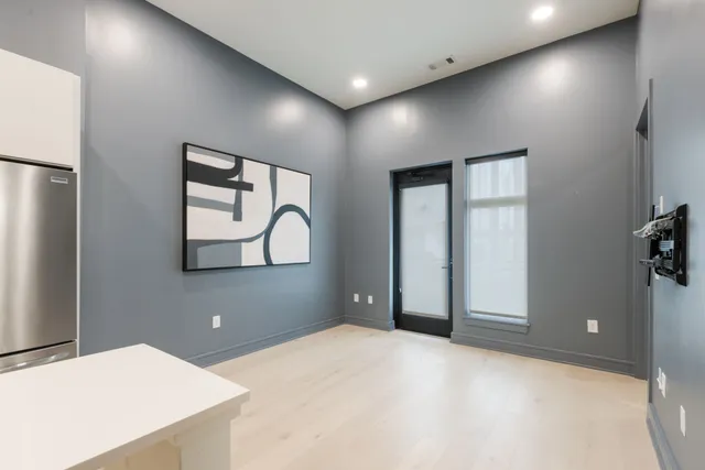 a view of a kitchen with refrigerator and windows