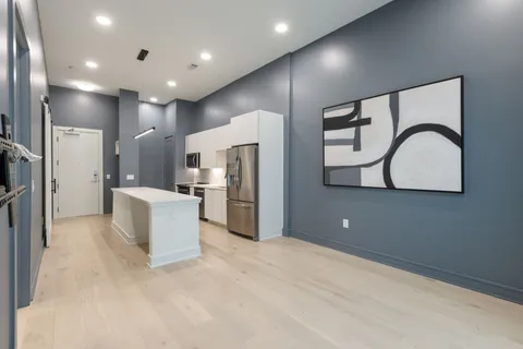 a bedroom with a bed and a night stand