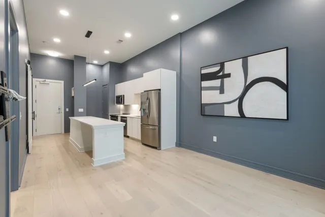 a bedroom with a bed and a night stand