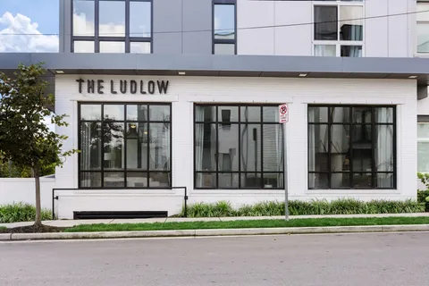 a kitchen with a refrigerator a sink and a stove top oven with wooden floor