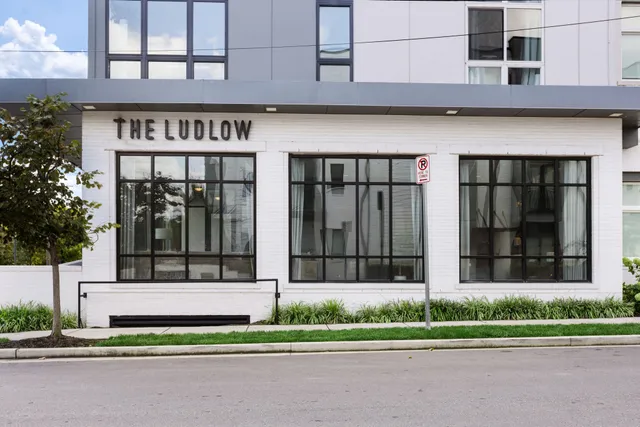 a kitchen with a refrigerator a sink and a stove top oven with wooden floor