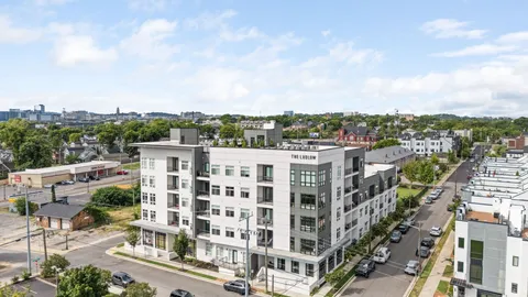 a view of city street with parked cars