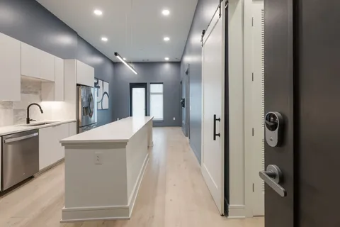 a kitchen with stainless steel appliances a stove microwave and cabinets