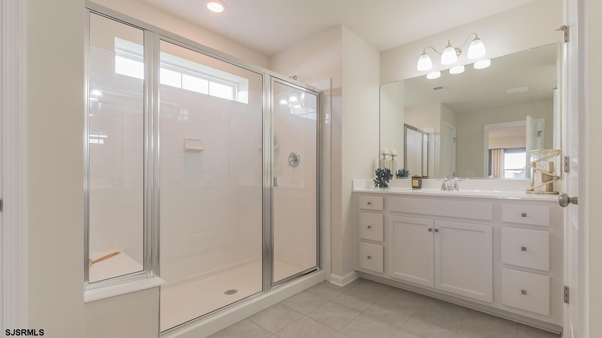 147 Leeds Point Road Galloway Township, NJ 08205 - Photo 23 of 24 a bathroom with a double vanity sink and mirror