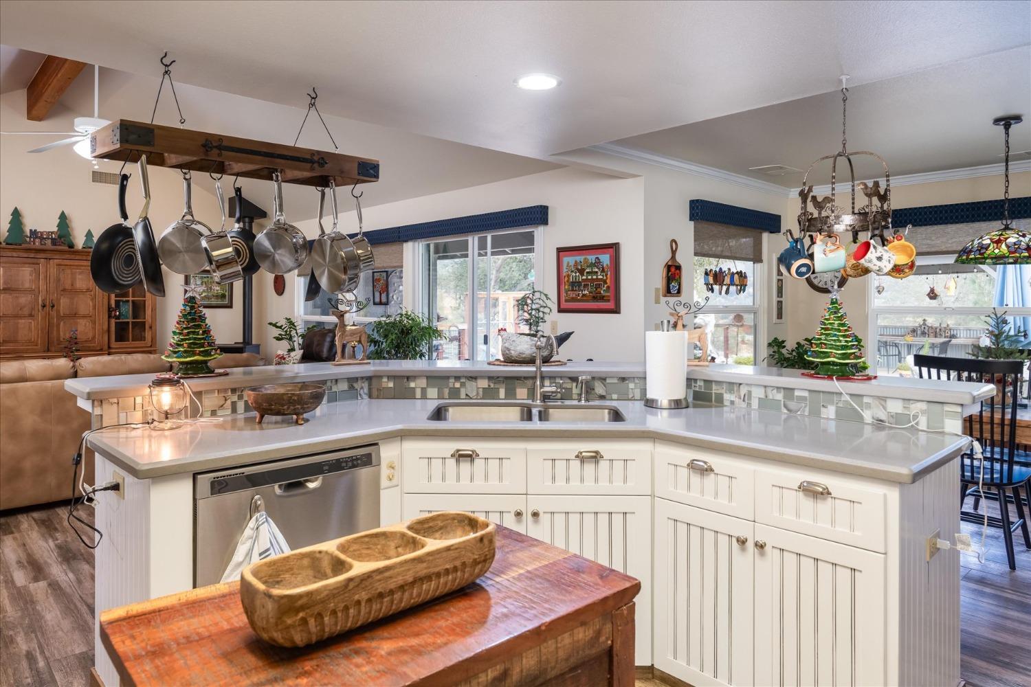 33655 River Knolls Road Coarsegold, CA 93614 - Photo 15 of 55 a kitchen with stainless steel appliances kitchen island granite countertop a sink and cabinets