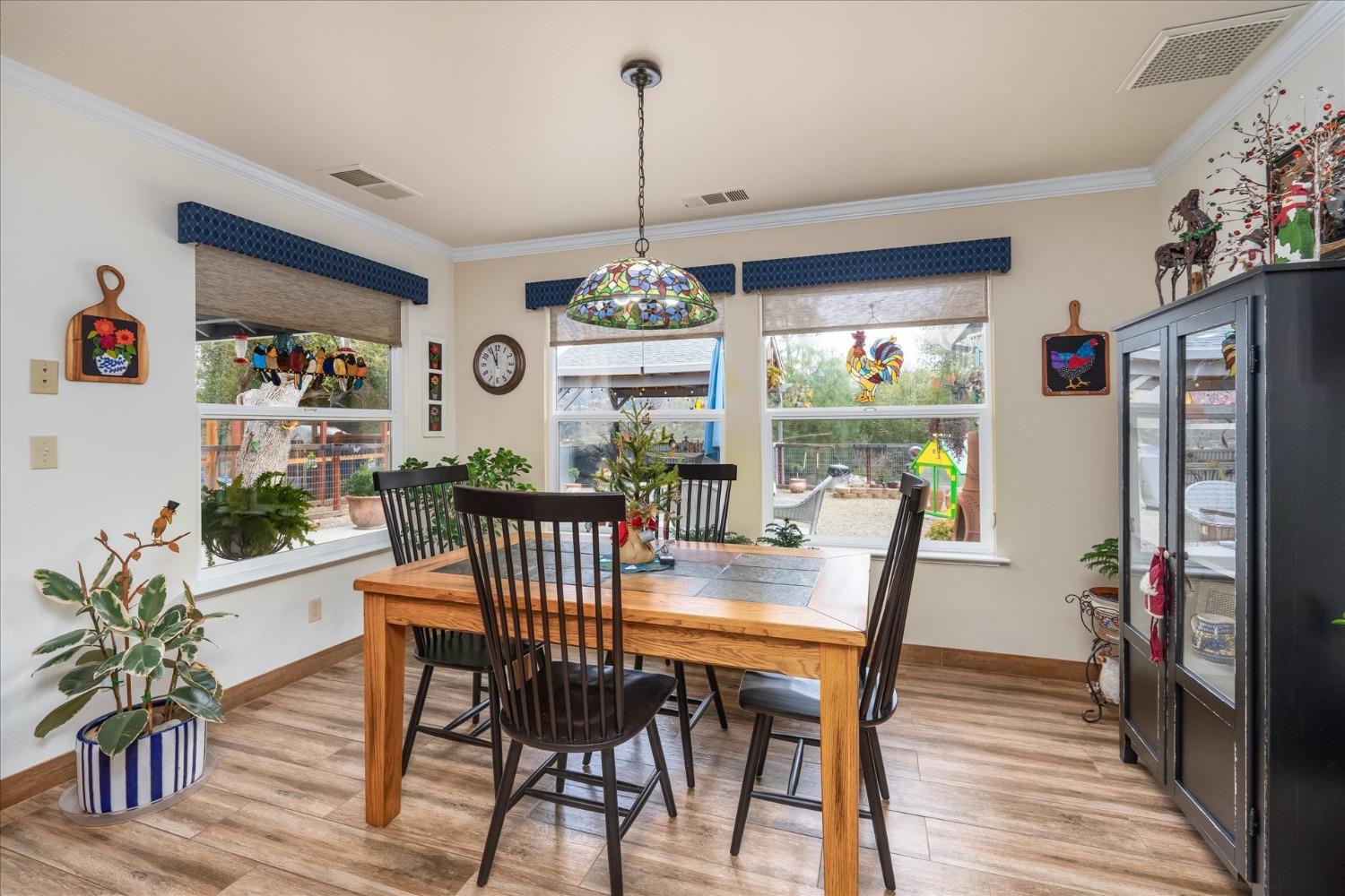 33655 River Knolls Road Coarsegold, CA 93614 - Photo 16 of 55 a view of a dining room with furniture window and wooden floor