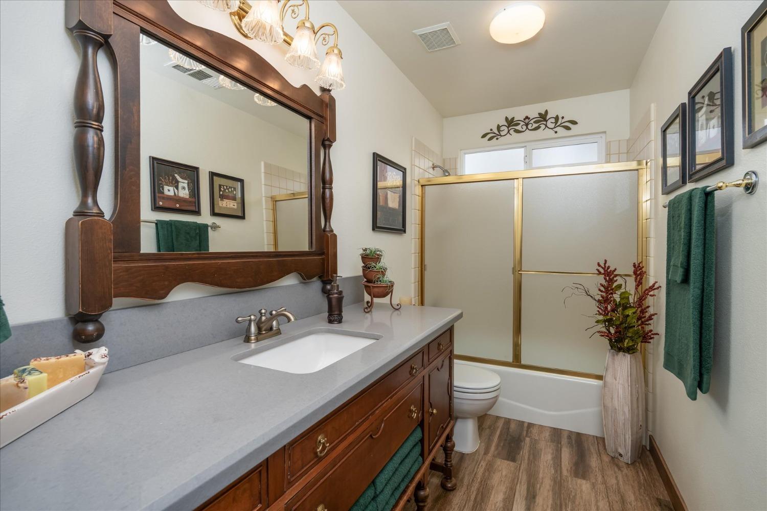 33655 River Knolls Road Coarsegold, CA 93614 - Photo 32 of 55 a bathroom with a sink a toilet a mirror and shower