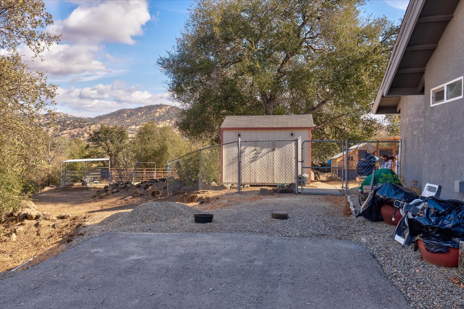33655 River Knolls Road Coarsegold, CA 93614 - Photo 46 of 55 a backyard of a house with fire pit and outdoor seating