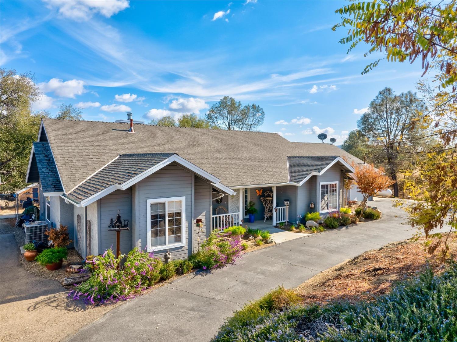 33655 River Knolls Road Coarsegold, CA 93614 - Photo 5 of 55 a front view of a house with a yard