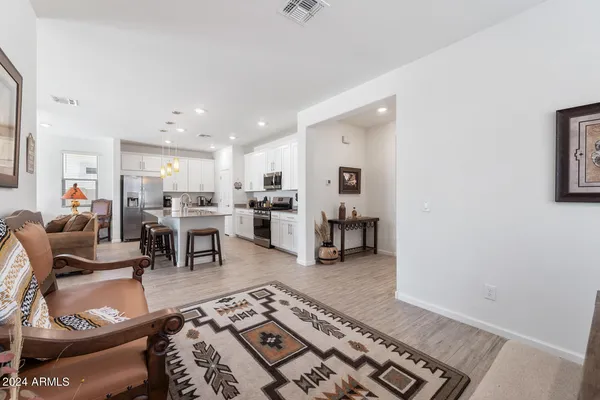 a living room with furniture and kitchen view