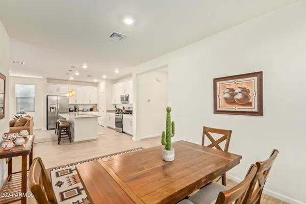 a living room with dining table and wooden floor