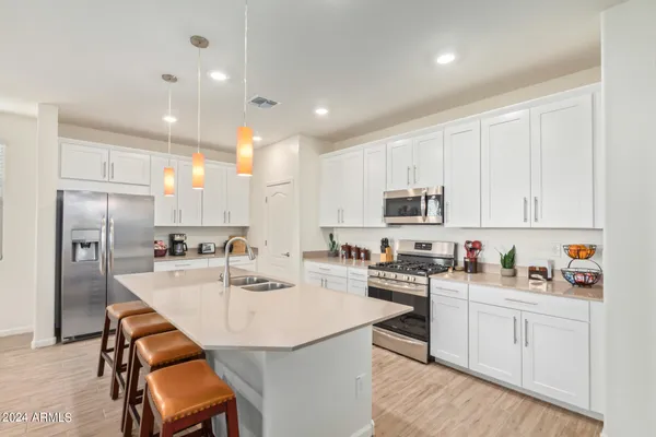 a kitchen with refrigerator a sink and cabinets