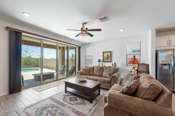a living room with furniture a table and a large window