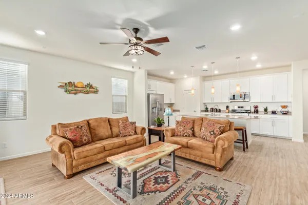 a living room with furniture and kitchen view